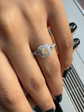 Natural Cushion Shaped Engagement Ring in 18K White Gold. Natural Diamonds with a Fancy Yellow Color center stone and VS Clarity.