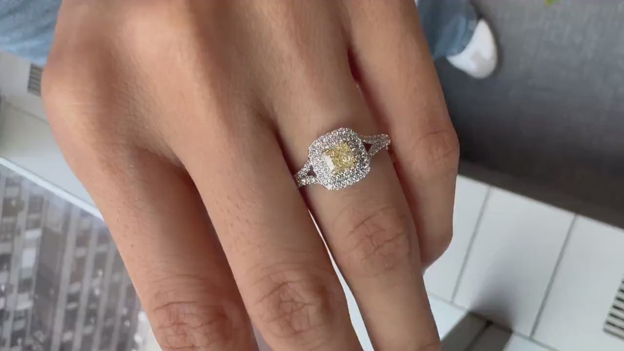 Natural Cushion Shaped Engagement Ring in 18K White Gold. Natural Diamonds with a Fancy Yellow Color center stone and VS Clarity.