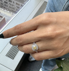Natural Cushion Shaped Engagement Ring in 18K White Gold. Natural Diamonds with a Fancy Yellow Color center stone and VS Clarity.