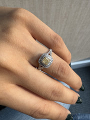 Natural Cushion Shaped Engagement Ring in 18K White Gold. Natural Diamonds with a Fancy Yellow Color center stone and VS Clarity.